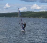 I learnt basic wind-surficing the first summer and crossed Bundefjorden during the second. I bought a lighter carbon fiber mast after<br>the first season and eventually had to replace the sail in 2018, however this was destroyed in 2021 during stormy weather.<br>The board has since not been used.